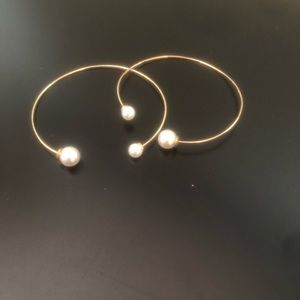 Gold hoop earrings with pearl accents
